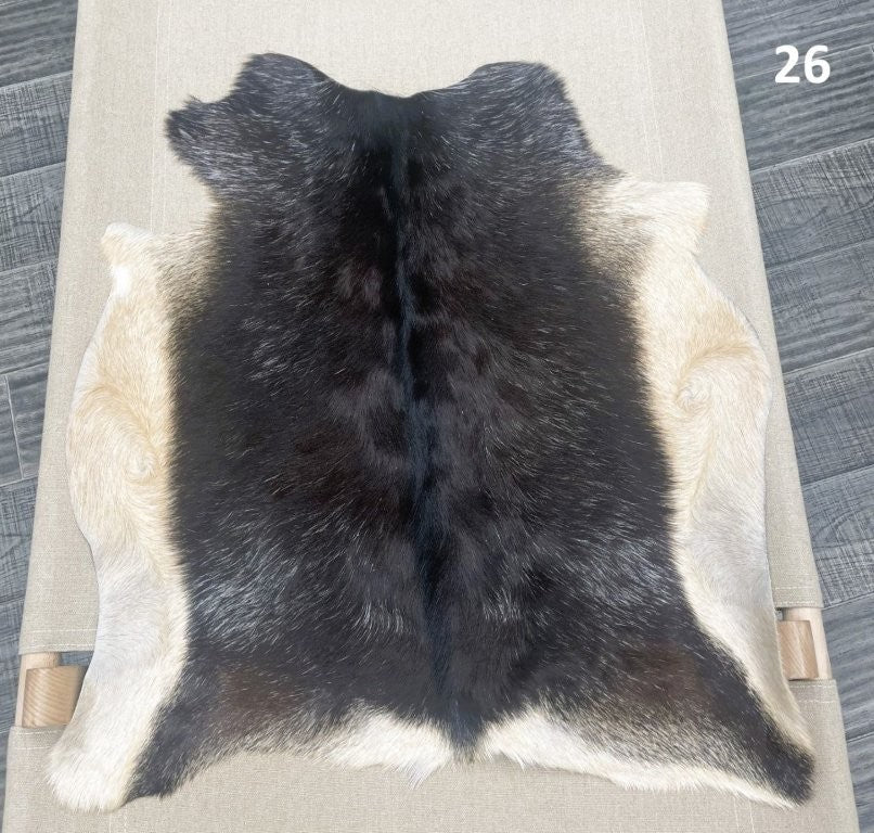 Natural goatskin hide rug shown individually