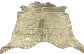 Gold metallic cowhide rug with speckled finish on natural hide displayed as a full rug