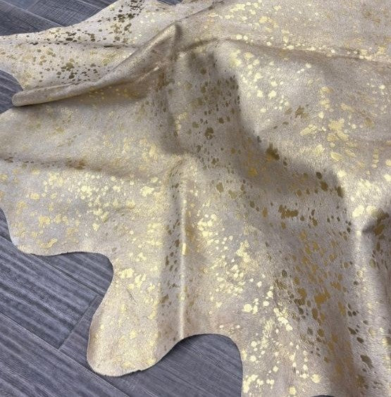 Gold metallic cowhide rug texture showing speckled finish on natural hair-on-hide leather