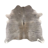 Grey beige cowhide rug example showing soft neutral tones and natural variation on a white background