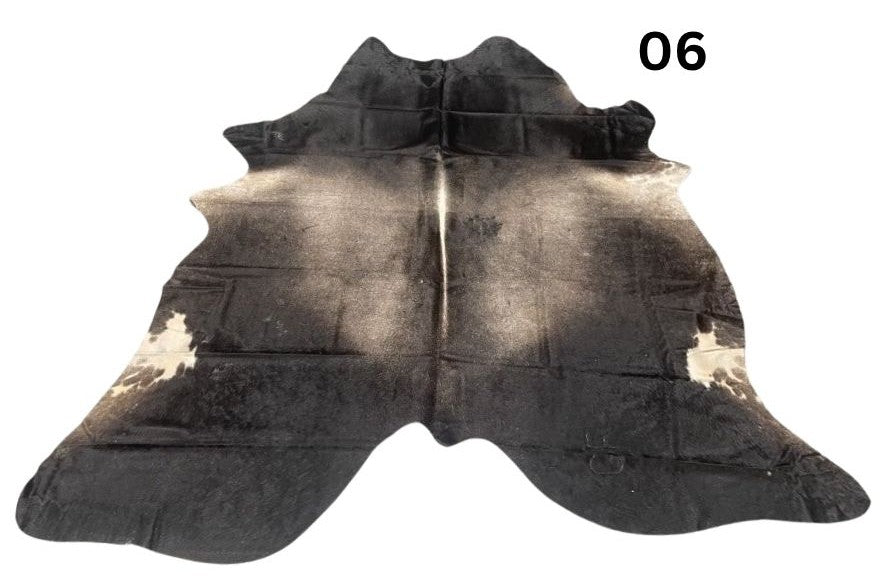 Grey cowhide rug number 06 with soft tonal variation and natural markings on a white background