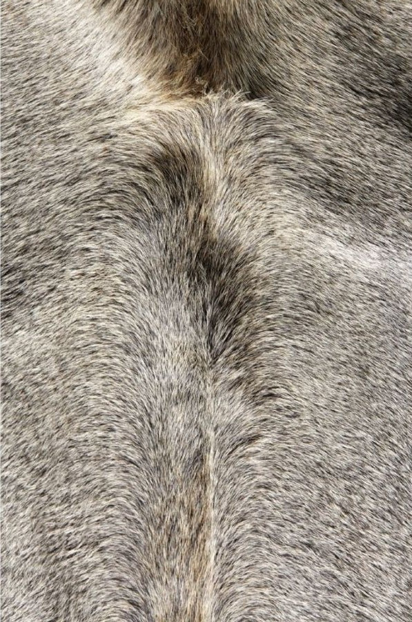 Close-up detail of a grey cowhide rug showing smooth natural hair texture and tonal variation