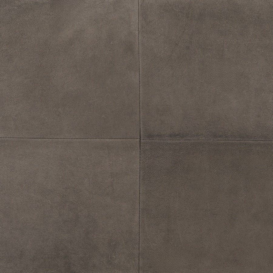 Close up of grey nubuck leather cushion showing soft matte texture and panel seam detail