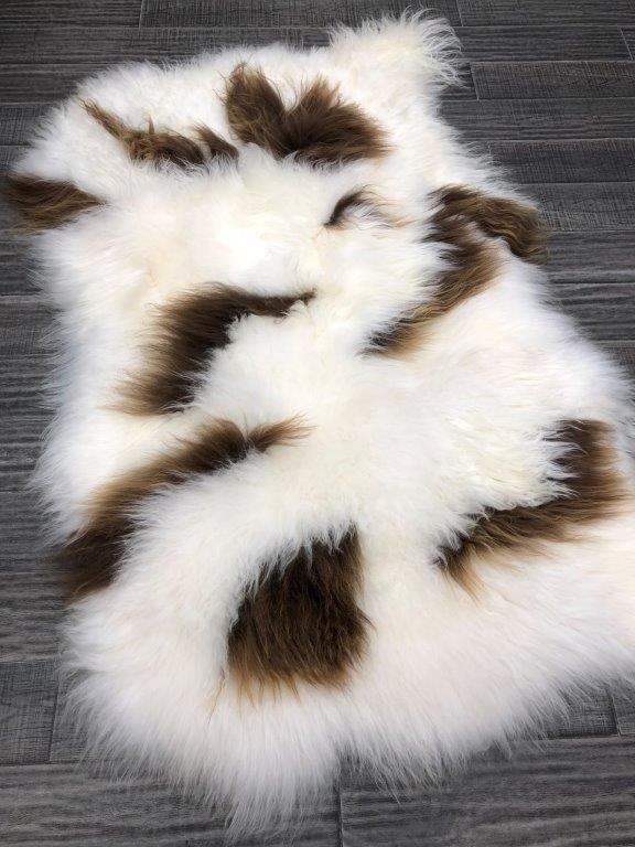 Icelandic sheepskin floor rug with natural brown and white spot pattern