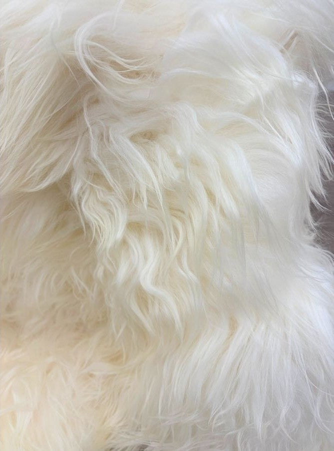 Close-up detail of long wool Icelandic sheepskin floor rug in natural white showing soft textured fleece