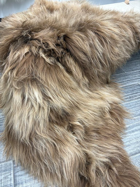 Close-up view of a triple dyed copper caramel Icelandic sheepskin floor rug highlighting long, soft wool fibres