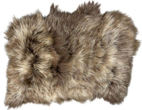 Triple dyed copper caramel Icelandic sheepskin floor rug shown on a white background, highlighting the natural shape and long wool fibres