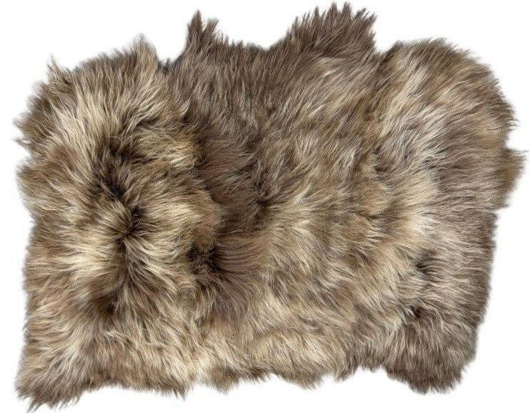 Triple dyed copper caramel Icelandic sheepskin floor rug shown on a white background, highlighting the natural shape and long wool fibres