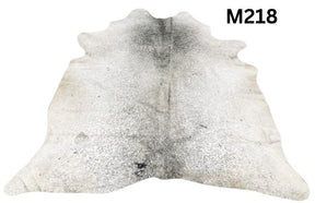 Light speckled longhorn cowhide rug number 218 with soft tonal variation and natural markings on a white background