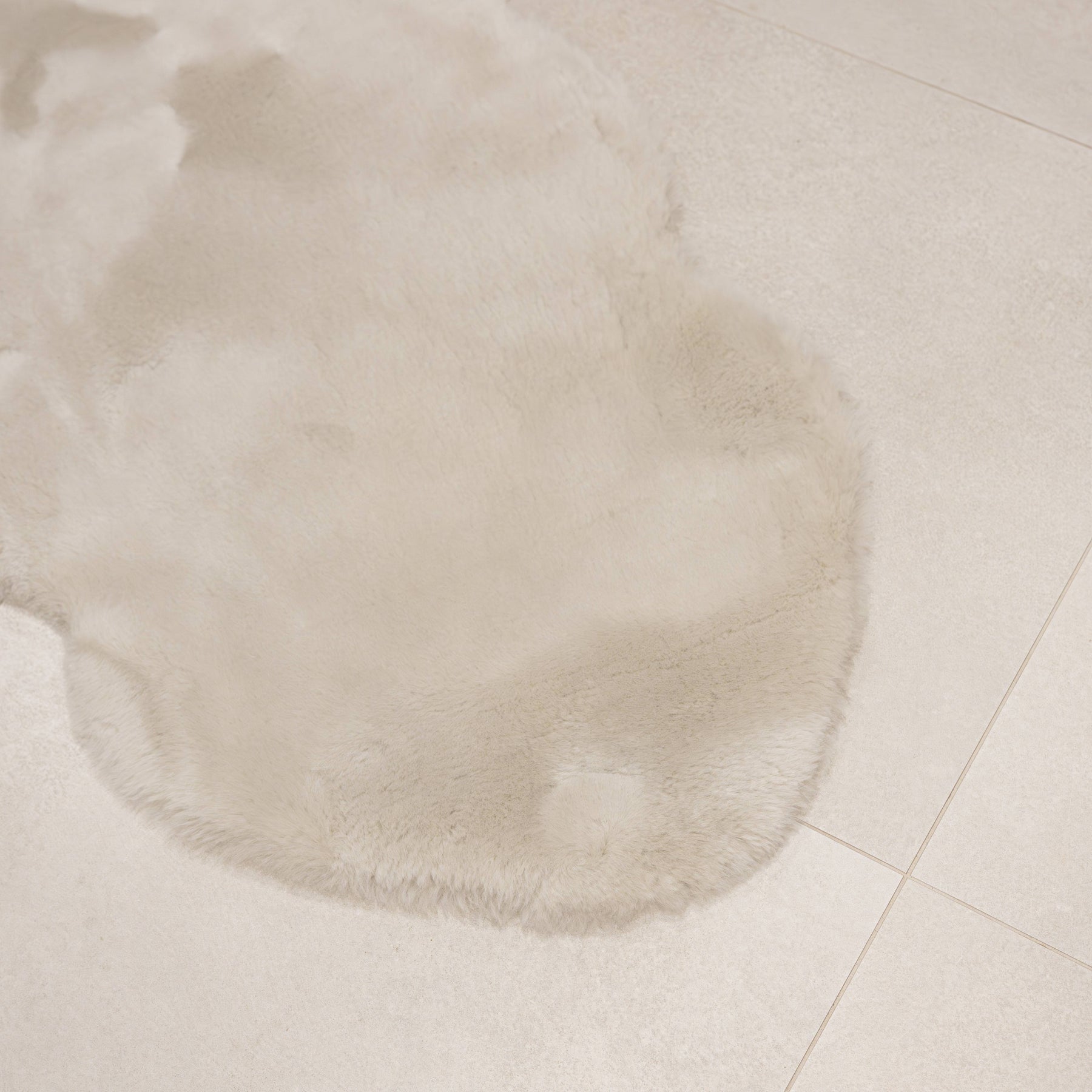 Linen sheepskin baby rug laid flat showing natural shape and soft wool texture