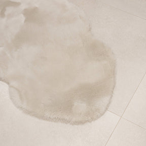 Linen sheepskin baby rug laid flat showing natural shape and soft wool texture