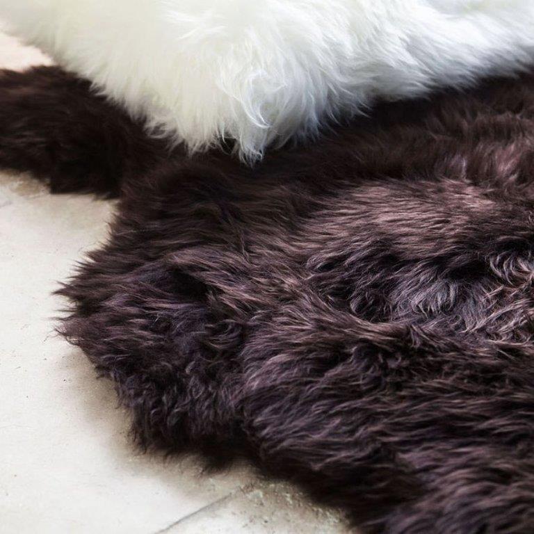 Close up of merino sheepskin rug in a rich chocolate tone showing soft dense wool texture