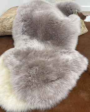 Close-up of merino sheepskin rug in mushroom tone showing dense, soft wool texture