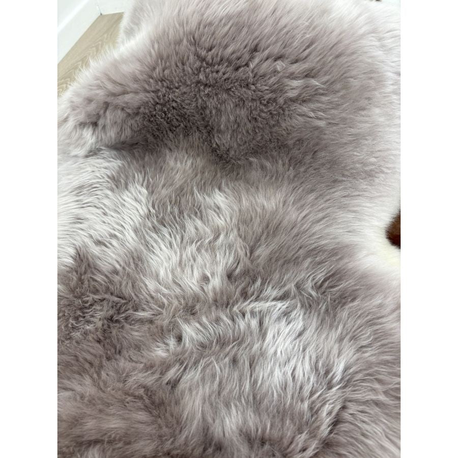 Detailed view of merino sheepskin rug in mushroom tone highlighting soft, plush wool pile
