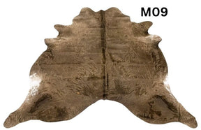 Mocha latte cowhide rug number 09 with natural tonal variation and markings on a white background