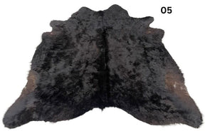 Natural black cowhide rug number 05 with subtle tonal variation and natural markings on a white background
