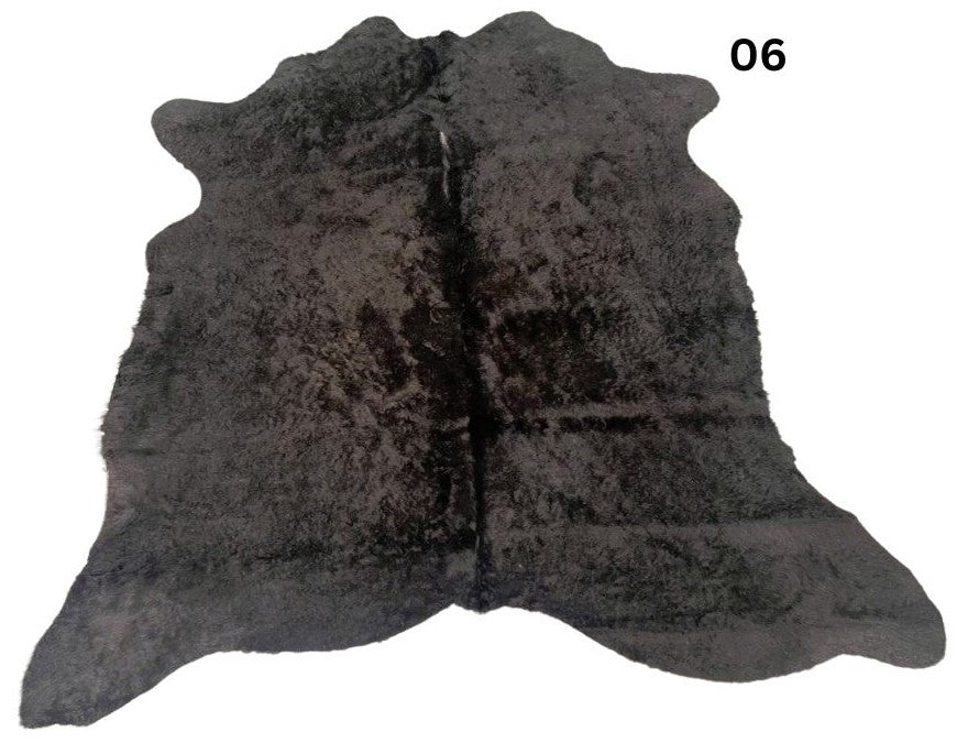 Natural black cowhide rug number 06 with subtle tonal variation and natural markings on a white background