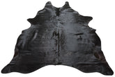 Natural black cowhide rug example showing rich dark tones and subtle variation on a white background