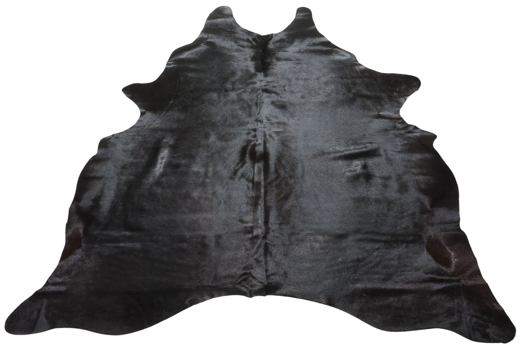 Natural black cowhide rug example showing rich dark tones and subtle variation on a white background