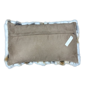 Reverse side of natural brown and white rabbit fur lumbar cushion with suede backing
