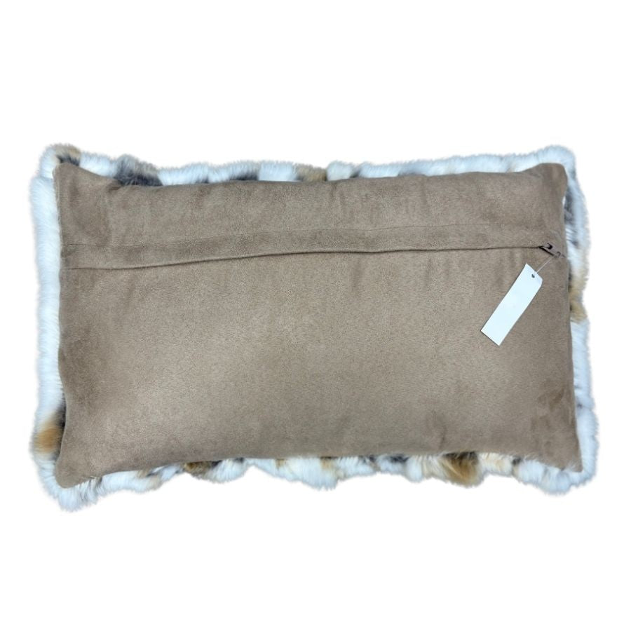Reverse side of natural brown and white rabbit fur lumbar cushion with suede backing