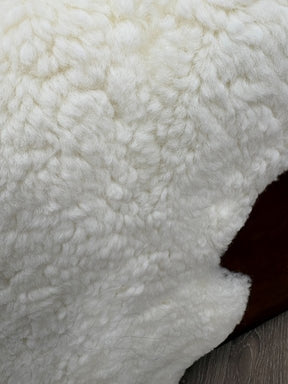 Detailed view of genuine natural white shearling with dense wool and a soft, plush finish.