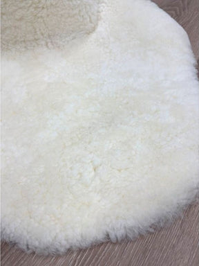 Detailed view of genuine natural white shearling with soft, dense wool and a luxurious finish.