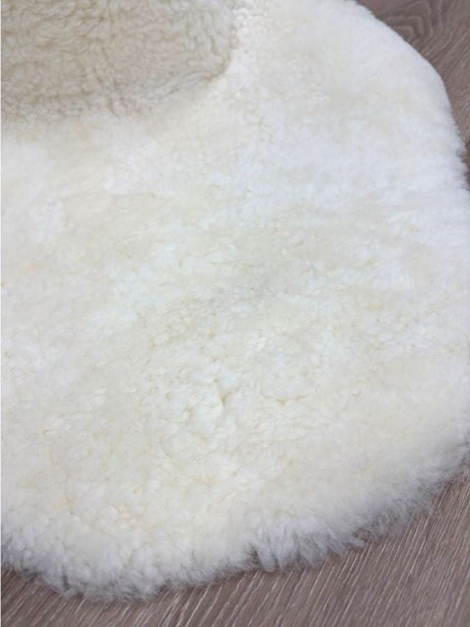 Detailed view of genuine natural white shearling with soft, dense wool and a luxurious finish.