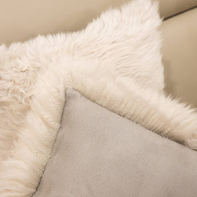 Close-up of New Zealand sheepskin cushion in linen showing soft long wool front and fabric backing detail