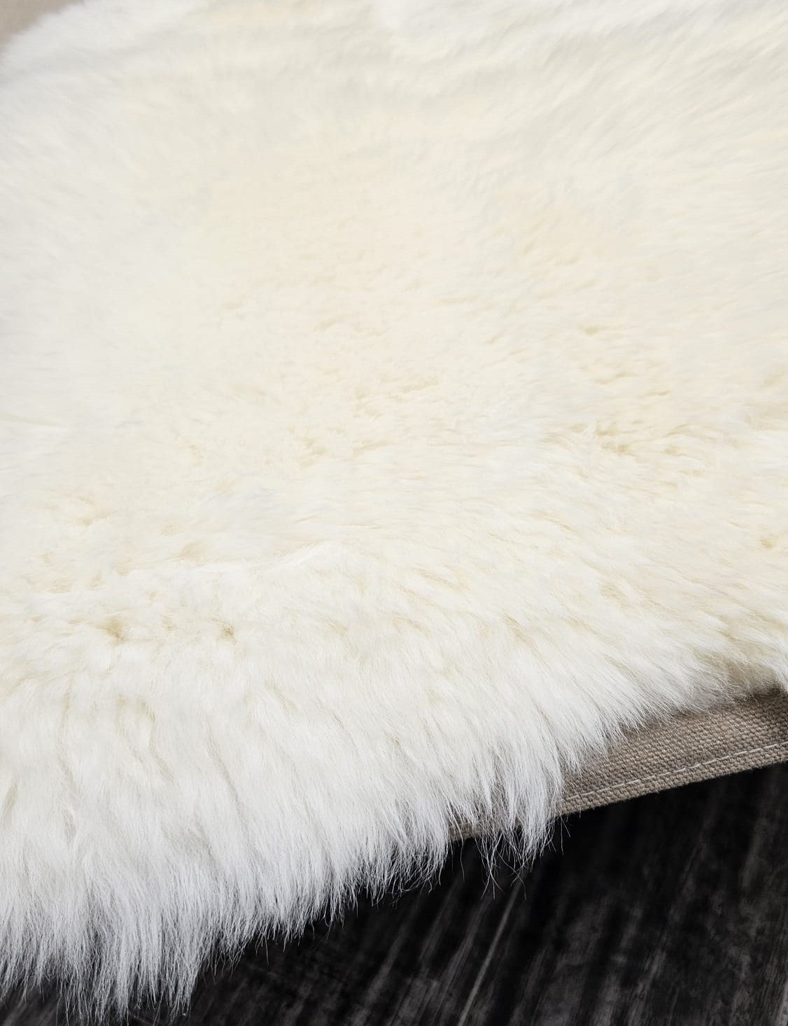 Edge detail of natural white New Zealand sheepskin rug