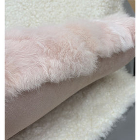 Soft pink rabbit fur lumbar cushion with suede backing detail