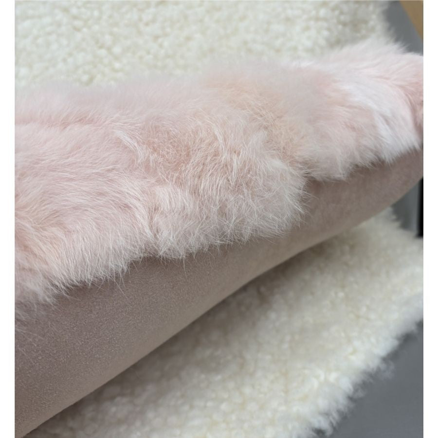 Soft pink rabbit fur lumbar cushion with suede backing detail