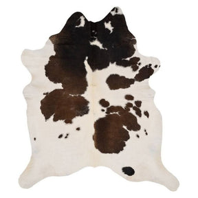 Large reddish brown cowhide rug example showing natural markings and colour variation on a white background