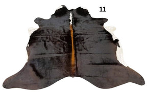 Small reddish brown cowhide rug number 11 with lighter central tones and natural markings on a white background