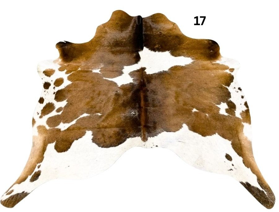 Reddish brown cowhide rug small size hide 17 genuine hide with lighter base and scattered brown markings displayed on white background