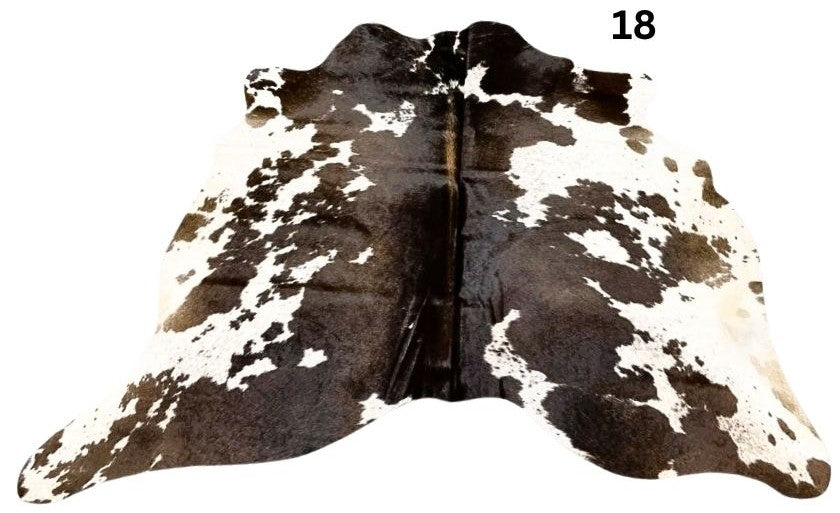 Reddish brown cowhide rug small size hide 18 genuine hide with lighter base and scattered brown markings displayed on white background