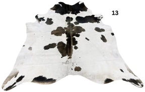 Reddish brown and white cowhide rug number 13 with natural markings and speckled pattern on a white background