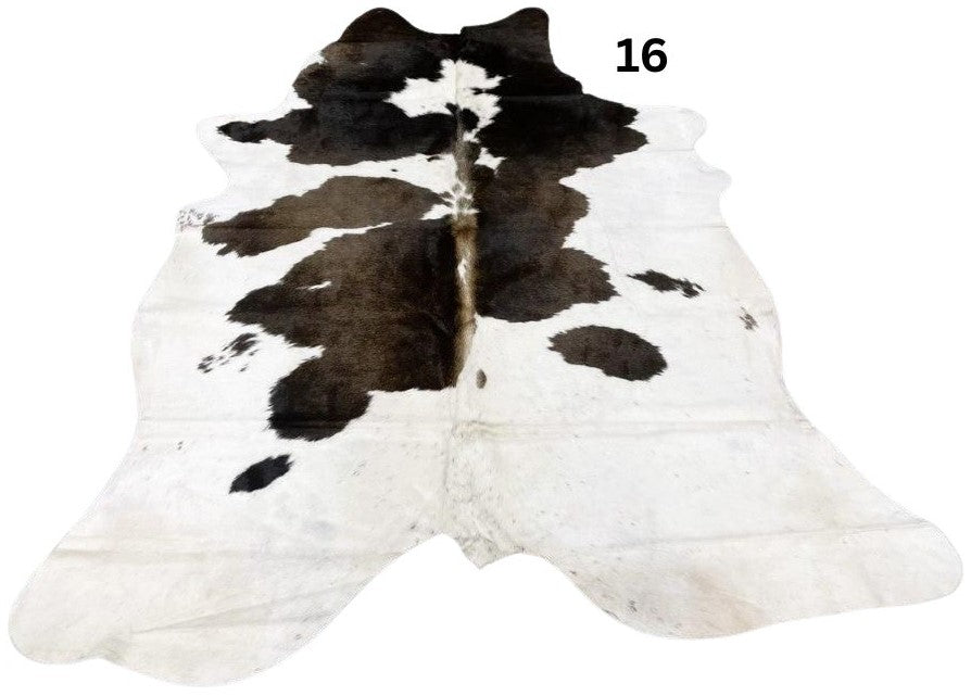 Reddish brown and white cowhide rug number 16 with natural markings and speckled pattern on a white background