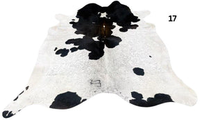 Reddish brown and white cowhide rug number 17 with natural markings and speckled pattern on a white background