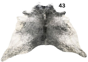 Salt and pepper cowhide rug number 43 with natural markings on a white background