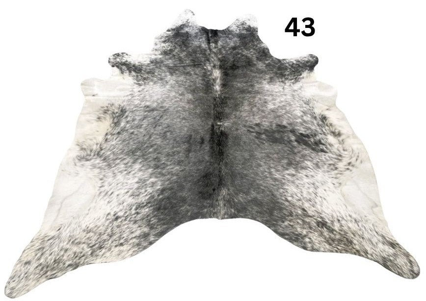 Salt and pepper cowhide rug number 43 with natural markings on a white background