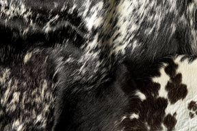 Close-up detail of natural salt and pepper cowhide rug showing black and white hair texture and markings