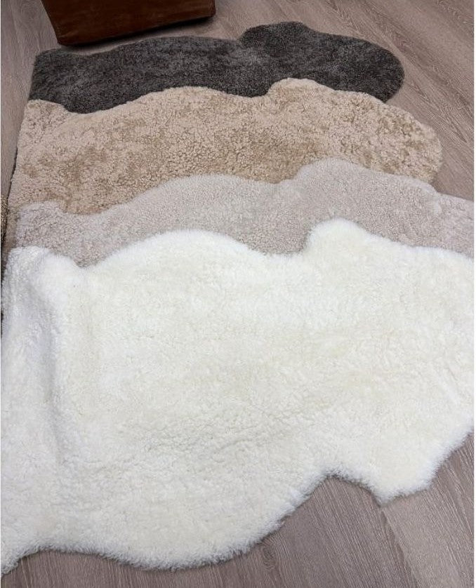 Shearling rug colour collection featuring Natural White, Oatmeal, Honey and Chocolate Fleck shearling rugs.