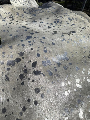 Close-up of silver metallic cowhide rug showing speckled finish on natural hair-on-hide leather