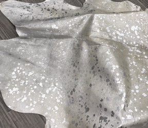 Silver metallic cowhide rug texture showing speckled finish on natural hair-on-hide leather