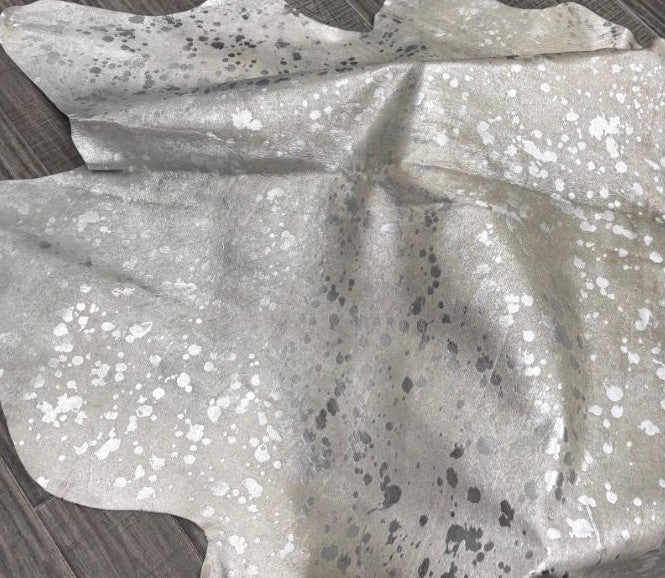 Silver metallic cowhide rug texture showing speckled finish on natural hair-on-hide leather