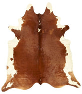Small brown and white Hereford cowhide rug with natural shape and balanced markings on a white background