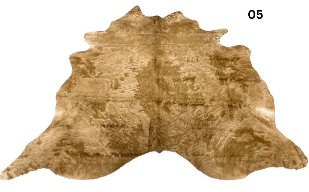Solid beige cowhide rug number 05 with soft even tones and natural markings on a white background