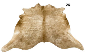 Solid beige cowhide rug number 26 with soft even tones and natural markings on a white background