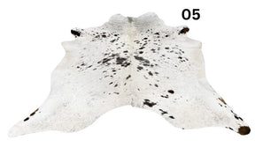 Speckled longhorn cowhide rug number 05 with natural markings and tonal variation on a white background